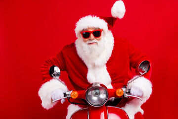 Photo of excited crazy elderly santa drive bike fast north pole christmas fairy isolated on vivid...