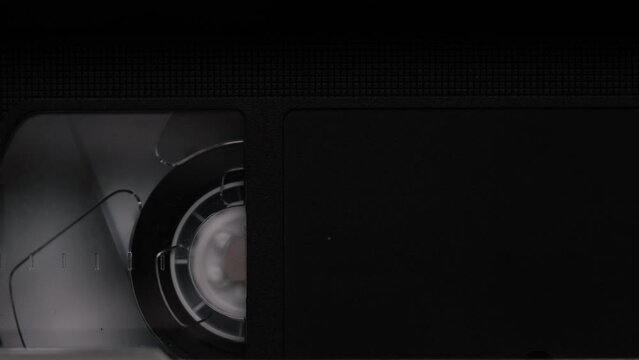 Close Up of VHS Video Tapes, Videocassettes Spinning. Vintage Video Media From 1980s and 1990s, Full Frame.