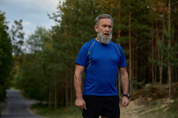 Naklejka premium Tired retired sportsman breathing hard after jogging exercise