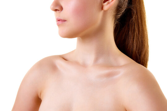 Close up cropped photo of young female body. Bare shoulders, neck, collarbones, bust of woman. Skincare cosmetic treatment affect.