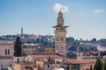 Fototapeta na wymiar A beautiful minaret stands over the old City of Jerusalem