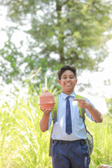 holding traditional piggy bank or Gullak