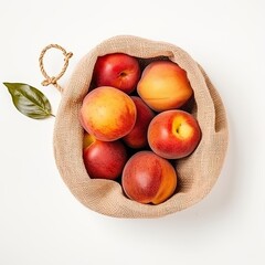 High angle view of nectarines on a rustic bag isolated on white background.