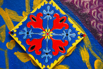 Handicraft retro tracery design ceramic and craft vintage marble tiles patterns on wall with graffiti street art in antique market 100 year arch bridge at Suratthani old town in Surat Thani, Thailand