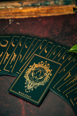 Oracle reading cards on red mat table with candles gemstones plants and encense