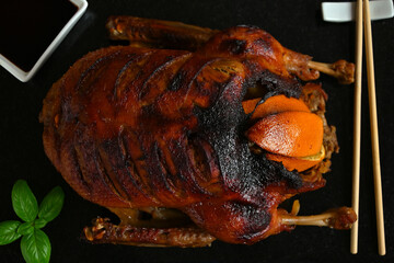 Chinese baked duck on a dark background close-up