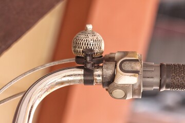 Beautiful splendid bike bell ensures security in the road traffic for bikers and pedestrians with a ringing noise as traffic safety and beautiful chromed decoration of a chromed handlebar - obrazy, fototapety, plakaty