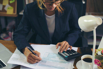 Season to pay Tax and Budget planning concept. Business woman calculating annual tax and using...