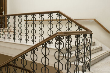Staircase between floors with metallic railing in the building