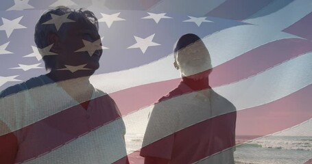 Animation of flag of usa over happy senior biracial couple in love walking on beach - Powered by Adobe