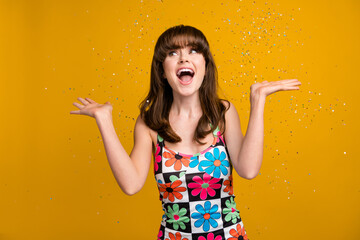 Photo of pretty shocked woman dressed flower print outfit falling confetti looking empty space...