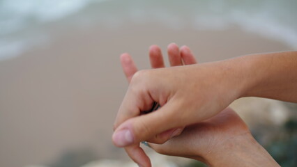 Hands holding sea shell at ocean shore closeup. Holiday vacation memories.