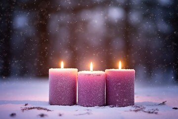 Burning Christmas candles in the snow