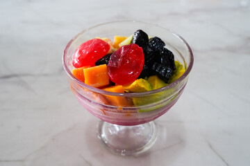 fruit ice, mixed ice (es buah) refreshing drink with ice cubes with fruit, in a serving glass