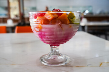 fruit ice, mixed ice (es buah) refreshing drink with ice cubes with fruit, in a serving glass