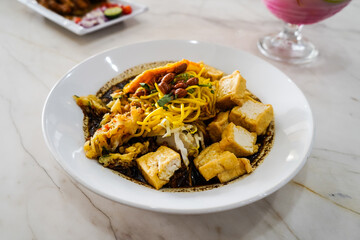 Kupat Tahu, with peanut sauce, Typical warm rujak snacks consist of rice cake, tofu and vegetables with spicy skinned peanuts and crackers on top. traditional Indonesian food, Central Java
