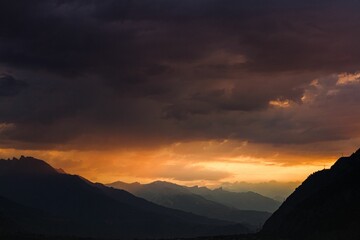 Summer landscape view of the sun rising through the clouds above the Wallis valley