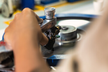 hand of woman african worker polishing a diamond in the factory at the spinning wheel
