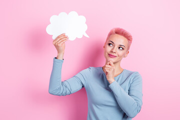 Portrait of thoughtful woman with dyed hairdo wear stylish clothes look at dialog cloud hand on chin isolated on pink color background