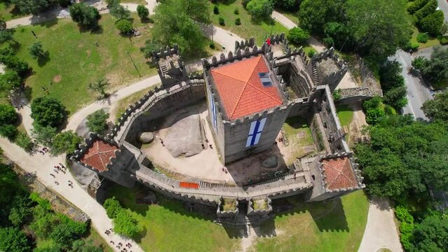 Aerial view of the Guimaraes Castle is the principal medieval castle in the municipality of Guimaraes with old Portugal flags, the Northern region
