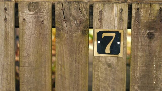 Number seven on a house gate post 