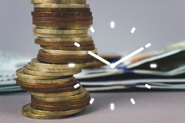 Coins stack and stack of one hundred dollar bills with Digital alarm clock symbol on grey background. Time is money.