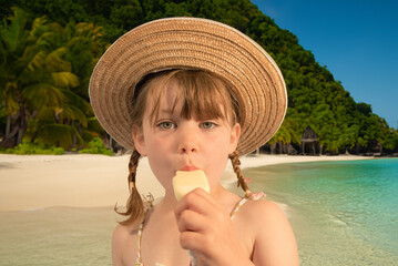 Cut young girl eating a delicious ice cream on the edge of a tropical lagoon