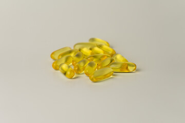 Omega-3-rich wild salmon and fish oil capsules against a gentle off-white background.