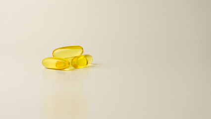 Omega-3-rich wild salmon and fish oil capsules presented on a soft off-white background.