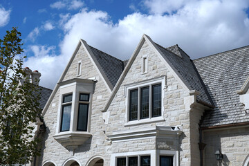 Retro style house with stone gable and leaded glass windows