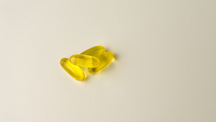 Omega-3-rich wild salmon and fish oil capsules presented on a soft off-white background.