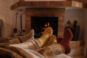 Winter socks next to a wood-burning fireplace to combat the cold. Concept: winter, cold days, shelter