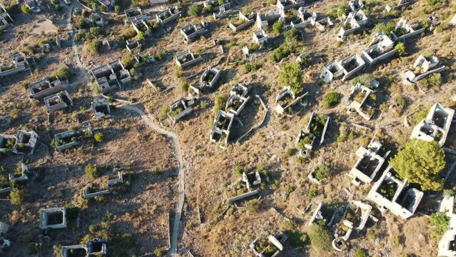 Aerial view of Kayak&ouml;y ghost town near Fethiye &Ouml;l&uuml;deniz in Turkey. It is an old abandoned Greek village. A classic with its neighborhoods of stone houses. Houses and path are visible.