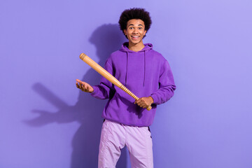 Portrait of cheerful carefree nice young man toothy smile hands hold baseball bat isolated on...