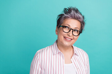 Photo of middle age businesswoman wear shirt grey dyed haircut dreaming look empty space count her budget isolated on cyan color background