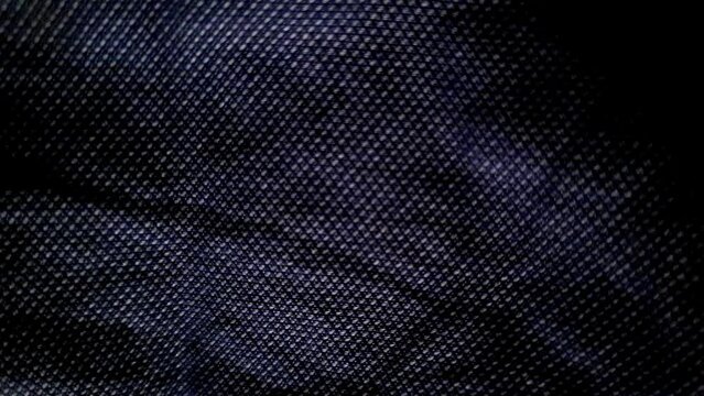 Woolen Knitted Dark Blue Fabric, Detailed Texture, Close up, Macro. Cozy Wool Blanket, Bedspread, Textile, Thin Yarn, Knit, Warm Sweater. Dark Blue Fabric Background. Factory Shop Woolen Products.