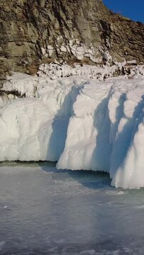 Around view of frozen Lake Baikal, Olkhon Island, Rock cape. Siberia, Russia. Vertical video