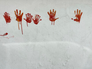 bloody red hands print on white wall for Halloween