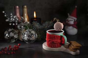 Decorating a Christmas composition with deer and a hot drink on a background, a place to copy and mug with splashes and drops of hot mulled wine at romantic moment