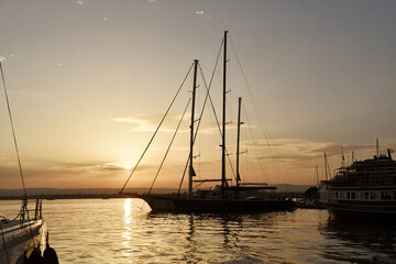 A boat floating on a sunset on a Sicilian coast from Italy 