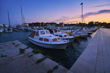 Fototapeta premium Port on the Adriatic Sea in the Croatian town of Krk with moored boats at sunset.