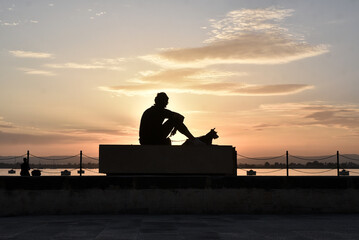 Person watching a sunset at sicily italy 