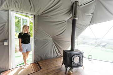 woman in dome tent. Glamping vacation lifestyle concept.