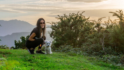 Happy Young Woman Smiling with Canine Companion in Rural Meadow