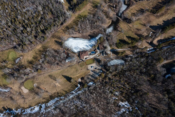 Winter aerial view of Barrie golf course, Ontario, showcasing serene snow patches, greens and...