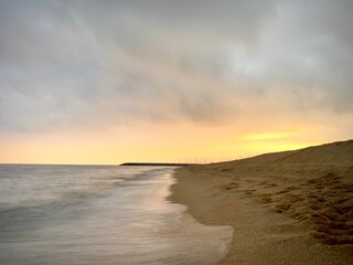 beautiful sunset on the beach of premia de mar, spain - obrazy, fototapety, plakaty