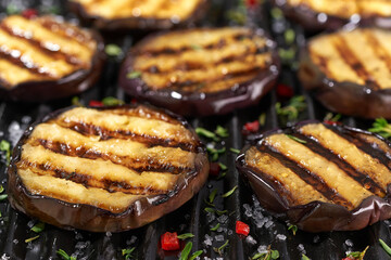 Fried eggplant slices in a grill, selective focus.