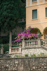 balcony with flowers in front the yellow house