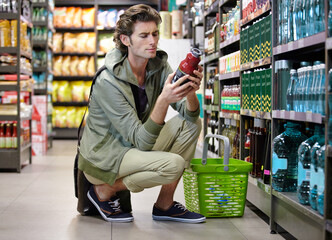 Man, read and label in grocery store or decision, confused or choice. Male person, thinking and...
