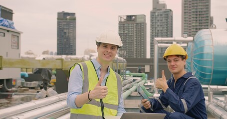 Portrait handsome Caucasian civil engineer Construction manager and worker inspector foreman in safety helmet looking at camera showing thumbs up and Smiling at construction site